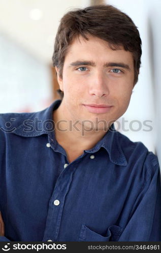 Portrait of young man standing on white background