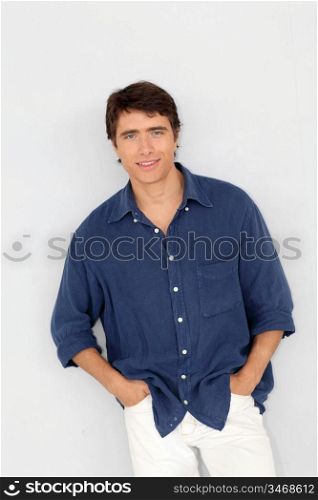 Portrait of young man standing on white background