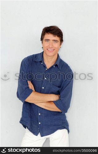Portrait of young man standing on white background