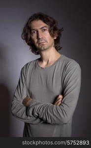 Portrait of young man thinking on a black background