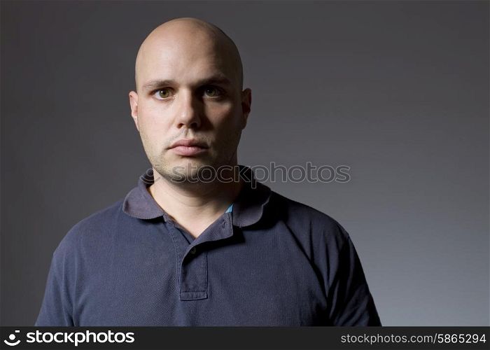 Portrait of young man thinking on a black background