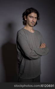 Portrait of young man thinking on a black background