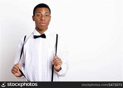Portrait of young man wearing suspenders over white background