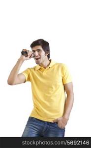 Portrait of young man with a microphone singing