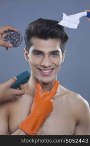 Portrait of young man with cleaning equipment