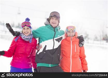 Portrait of young man with female friends enjoying in snow