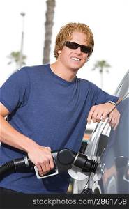 Portrait of young man with fuel pump