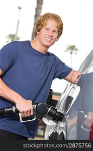 Portrait of young man with fuel pump