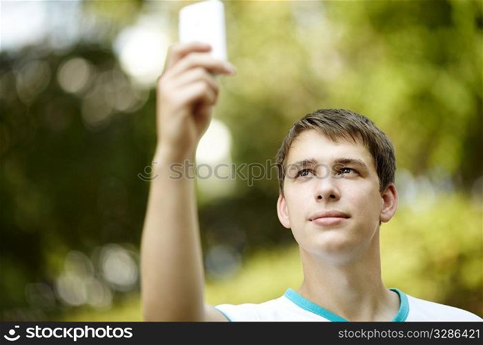 portrait of young man with gadget ,ambient light and silver reflection, focus on eye