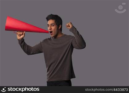 Portrait of young man with megaphone cheering