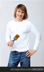 Portrait of young man with paint brushes