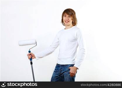 Portrait of young man with paint brushes