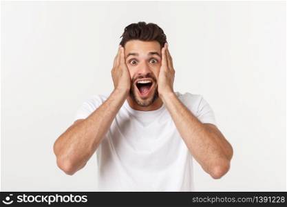 Portrait of young man with shocked facial expression, isolated over white background. Portrait of young man with shocked facial expression, isolated over white background.