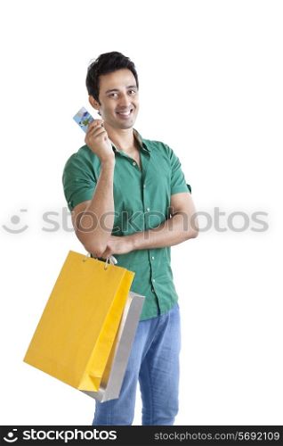 Portrait of young man with shopping bag and credit card
