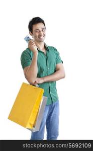 Portrait of young man with shopping bag and credit card
