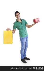 Portrait of young man with shopping bag and gift