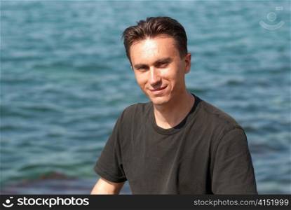 Portrait of young man with soft sea background