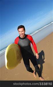 Portrait of young man with surfboard