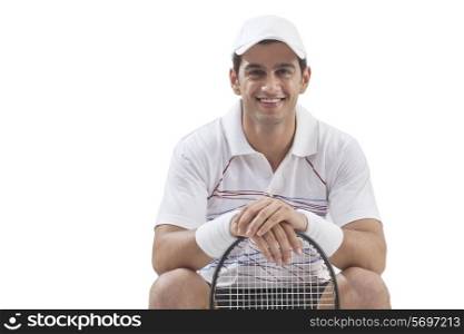 Portrait of young man with tennis racket isolated over white background
