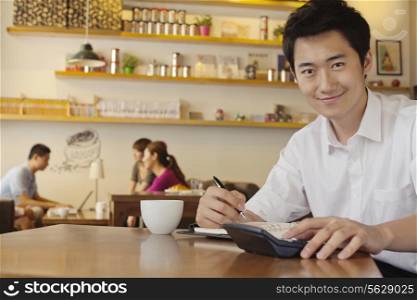 Portrait of young man working at a coffee shop