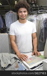 Portrait of young man working in dry cleaners