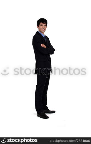 portrait of young manager standing cross-armed