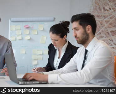 portrait of young modern arab business man with beard at office, group of business people on meeting making presentation in background