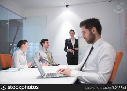 portrait of young modern arab business man with beard at office meeting room, group of business people on brainstorming and making plans and projects on white flip board in background