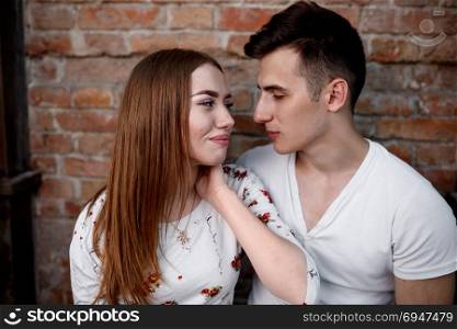 Portrait of young modern couple in love, posing outdoors in city street. Portrait of young modern couple in love, posing outdoors in city street.