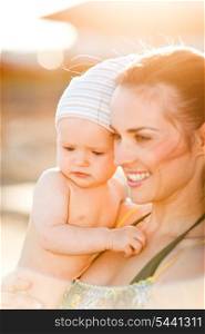 Portrait of young mom with baby on beach&#xA;
