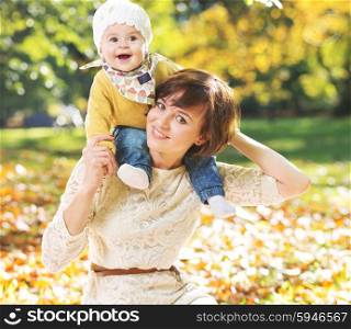 Portrait of young mother carrying cute baby