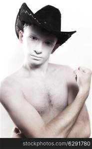Portrait of young naked man in cowboy hat isolated on white background