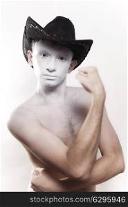 Portrait of young naked man in cowboy hat isolated on white background