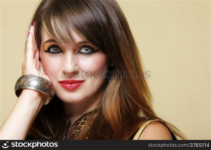 Portrait of young orient (eastern) girl with perfect make-up. Woman wearing traditional indian clothing. Perfect make-up.