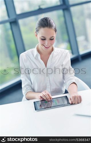portrait of Young pretty business woman work on notebook computer in the bright modern office indoors