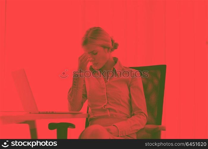 portrait of Young pretty business woman work on notebook computer in the bright modern office indoorsduo tone