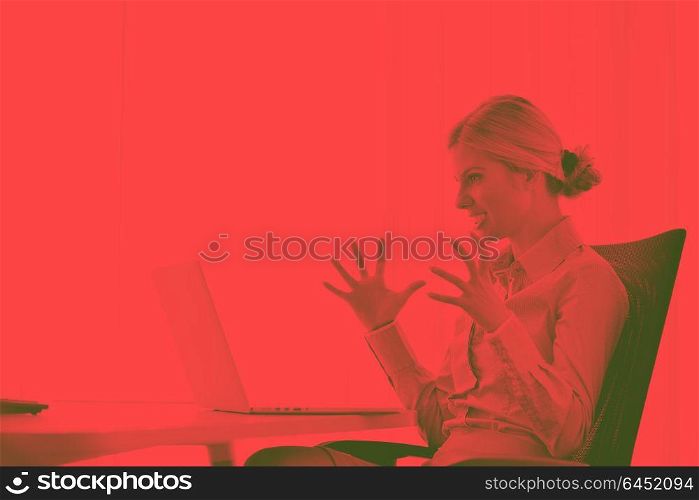 portrait of Young pretty business woman work on notebook computer in the bright modern office indoorsduo tone