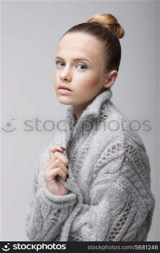 Portrait of Young Pretty Woman in Knitted Woolen Gray Jersey