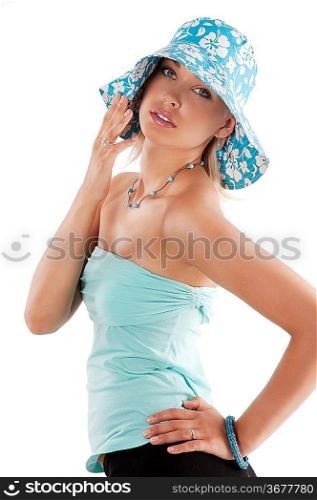 Portrait of young pretty woman in summer light blue dress with hat over white