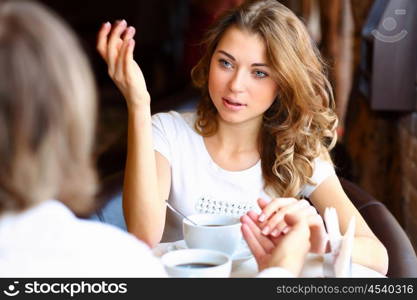 Portrait of young pretty woman sitting in restaurant