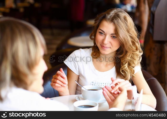 Portrait of young pretty woman sitting in restaurant