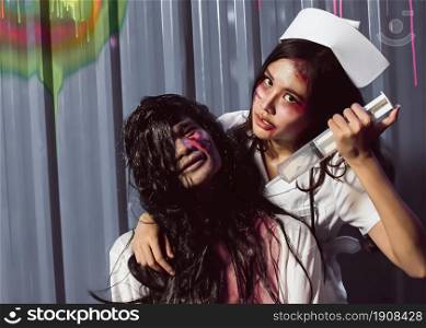 Portrait of young scary couple dressing nurse and patient halloween costume. Horror and Medical concept.
