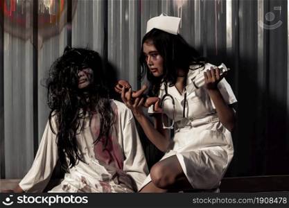 Portrait of young scary couple dressing nurse and patient halloween costume. Horror and Medical concept.