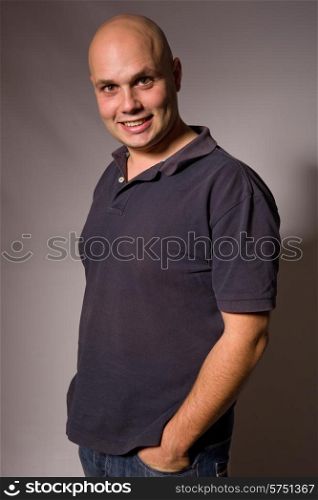 Portrait of young silly man on a dark background