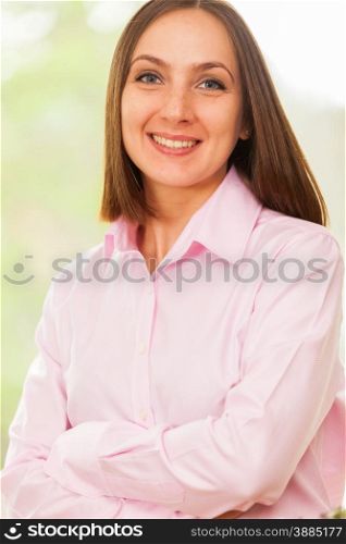Portrait of young smiling business woman with a pink shirt