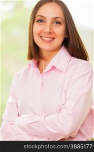 Portrait of young smiling business woman with a pink shirt