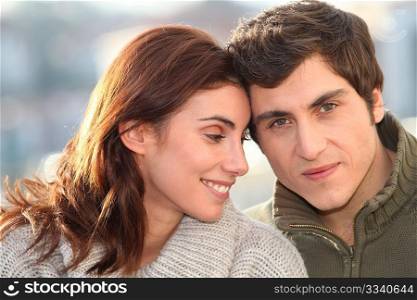 Portrait of young smiling couple in town