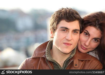 Portrait of young smiling couple in town