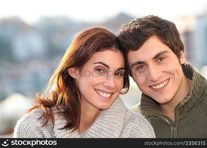 Portrait of young smiling couple in town