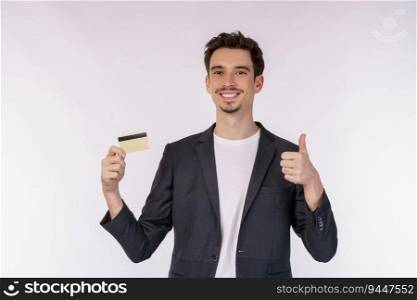 Portrait of Young smiling handsome businessman in casual clothes showing credit card and thumb up isolated over white background. Online shopping, ecommerce, internet banking, spending money concept.